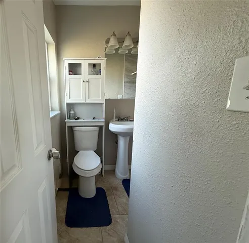 a bathroom with a toilet and a sink