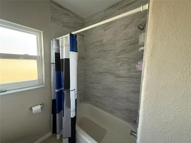 a bathroom with a bathtub and a shower
