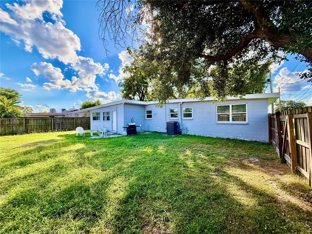 a view of a house with a backyard