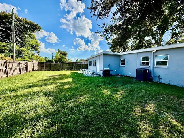a view of house with backyard