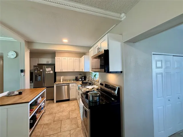 a kitchen with a sink stove and refrigerator