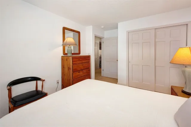 a bedroom with a bed and a dresser