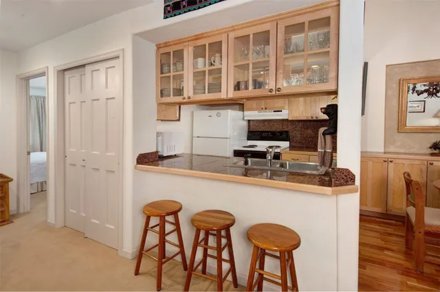 a kitchen with stainless steel appliances granite countertop a stove and cabinets
