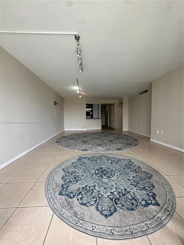 a view of a room with a fireplace and wooden floor