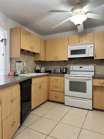 a kitchen with cabinets stainless steel appliances and a sink
