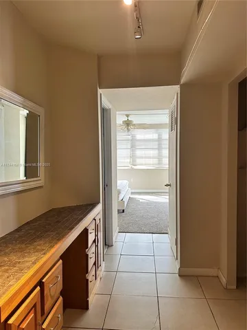 a kitchen with a refrigerator and cabinets