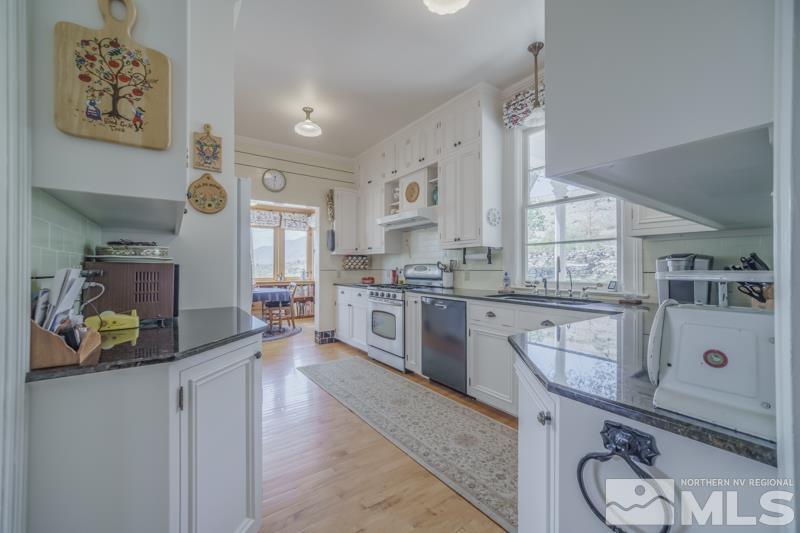 727 Highway 339 Yerington, NV 89447 - Photo 13 of 36 a kitchen with stainless steel appliances granite countertop a sink and cabinets