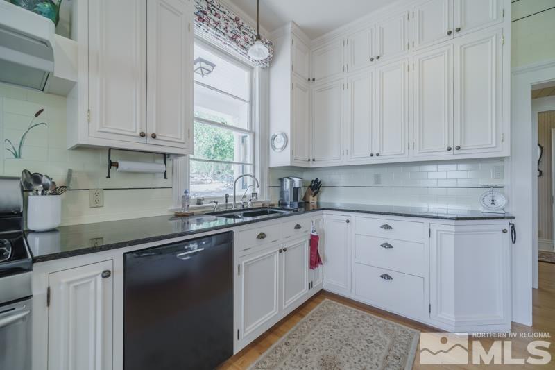 727 Highway 339 Yerington, NV 89447 - Photo 14 of 36 a kitchen with granite countertop white cabinets and sink