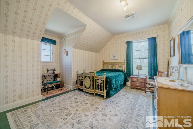 727 Highway 339 Yerington, NV 89447 - Photo 32 of 36 a bedroom with a bed and a couch