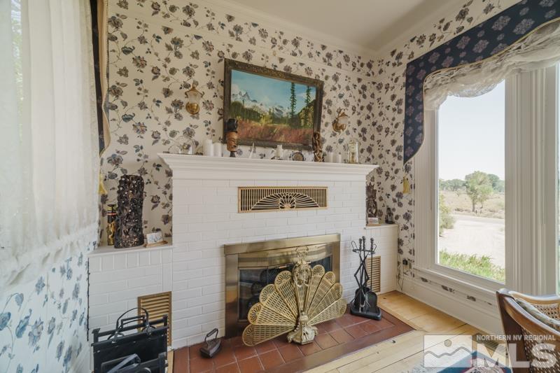727 Highway 339 Yerington, NV 89447 - Photo 6 of 36 a living room with a fireplace and a window