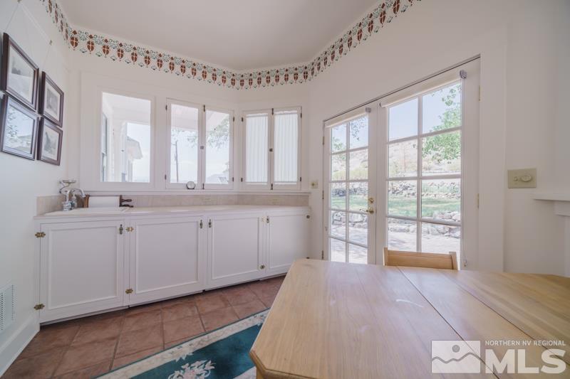 727 Highway 339 Yerington, NV 89447 - Photo 10 of 36 a spacious bathroom with a double vanity sink and a large mirror