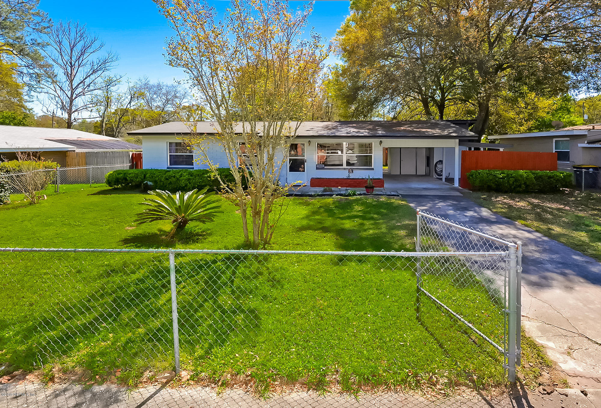 7442 Melvin Road Jacksonville, FL 32210 - Photo 1 of 17 a front view of a house with garden