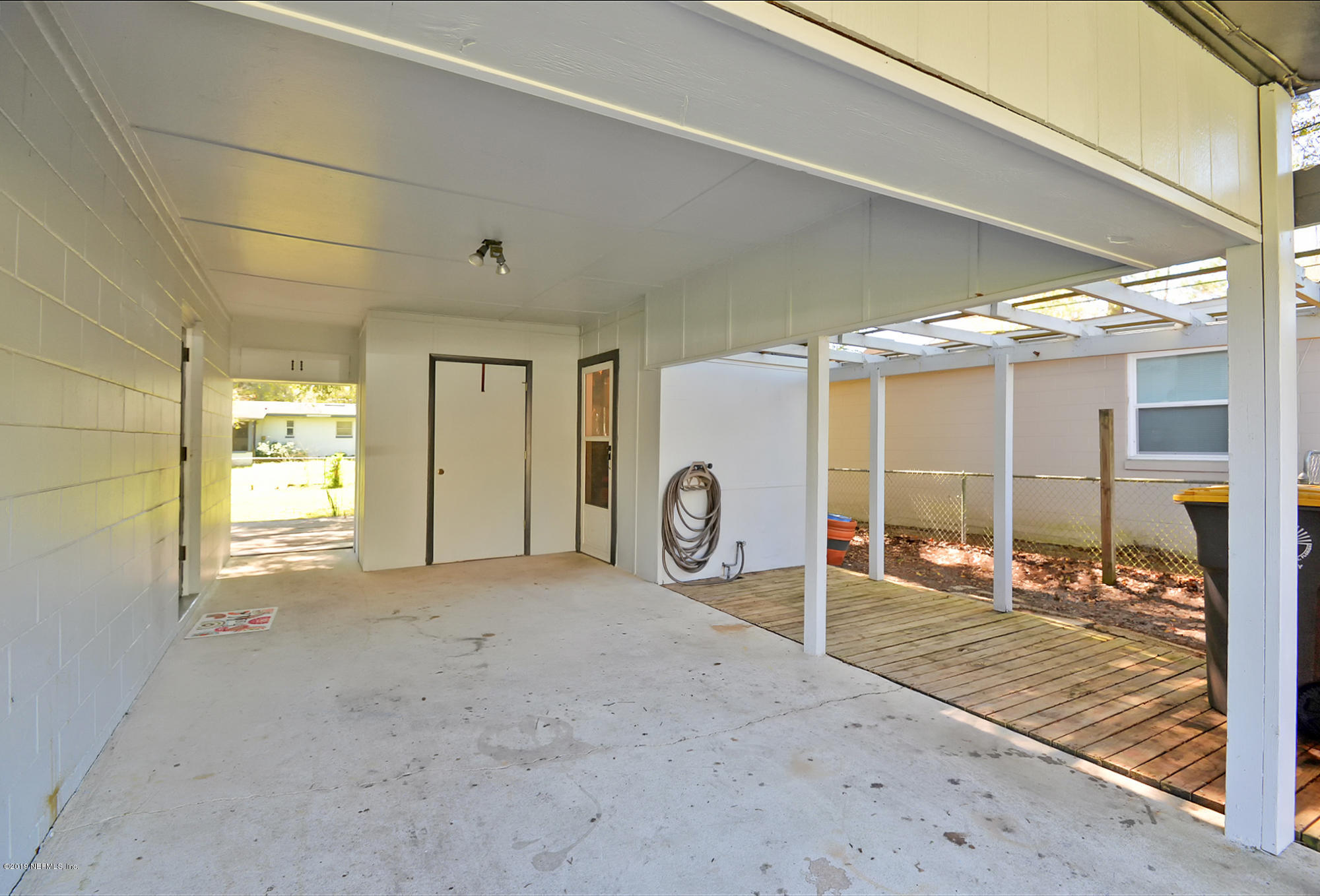7442 Melvin Road Jacksonville, FL 32210 - Photo 13 of 17 a view of a livingroom with wooden floor and a window