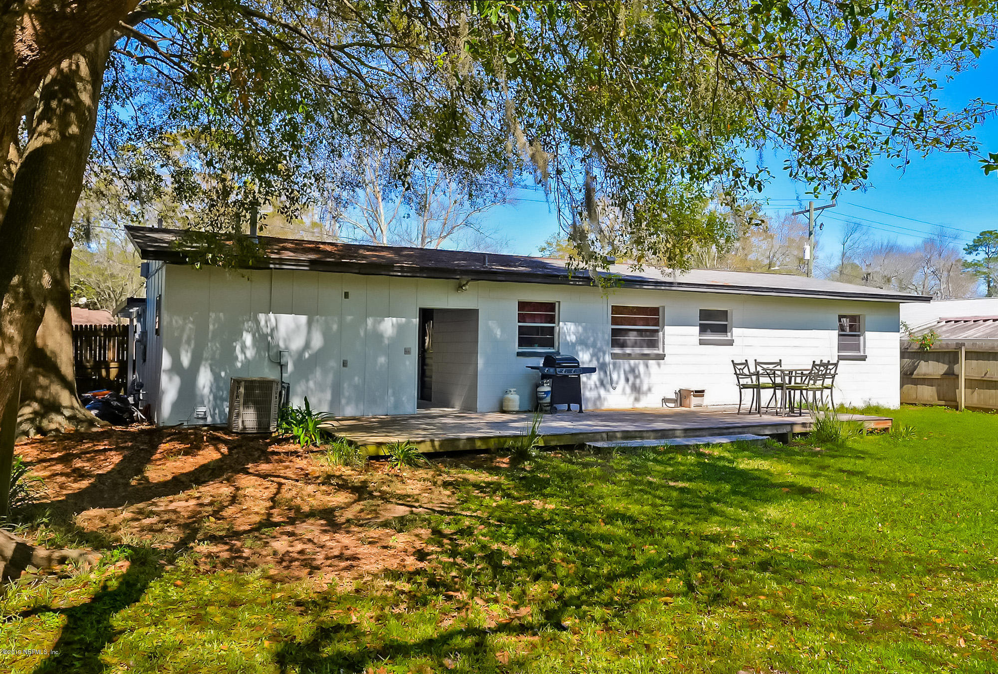 7442 Melvin Road Jacksonville, FL 32210 - Photo 14 of 17 a front view of a house with a garden and patio