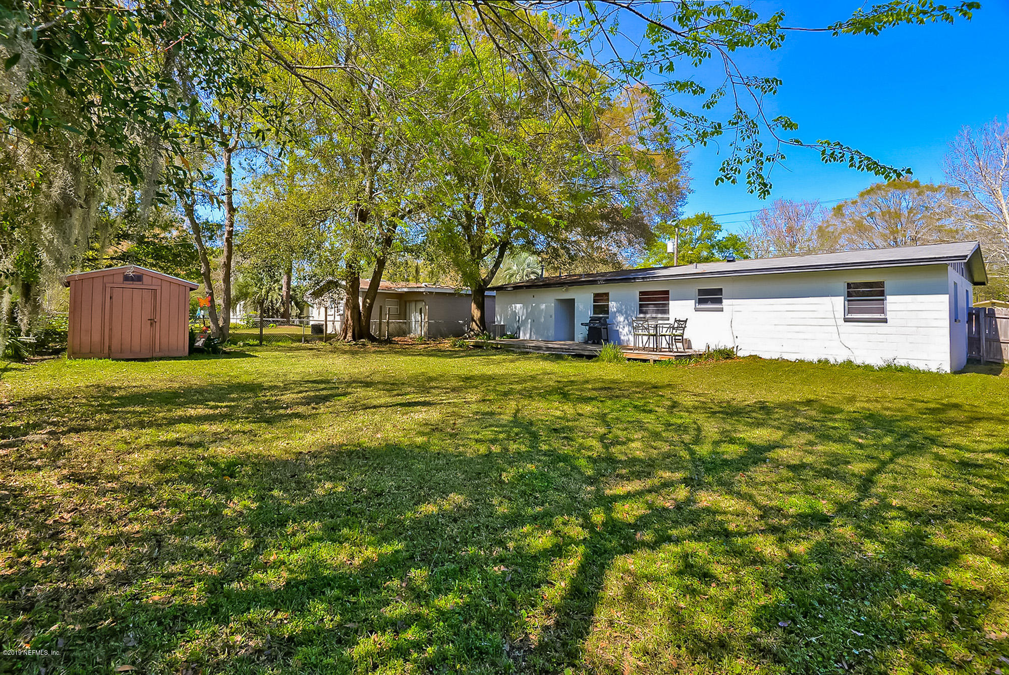 7442 Melvin Road Jacksonville, FL 32210 - Photo 15 of 17 a view of a house with a big yard