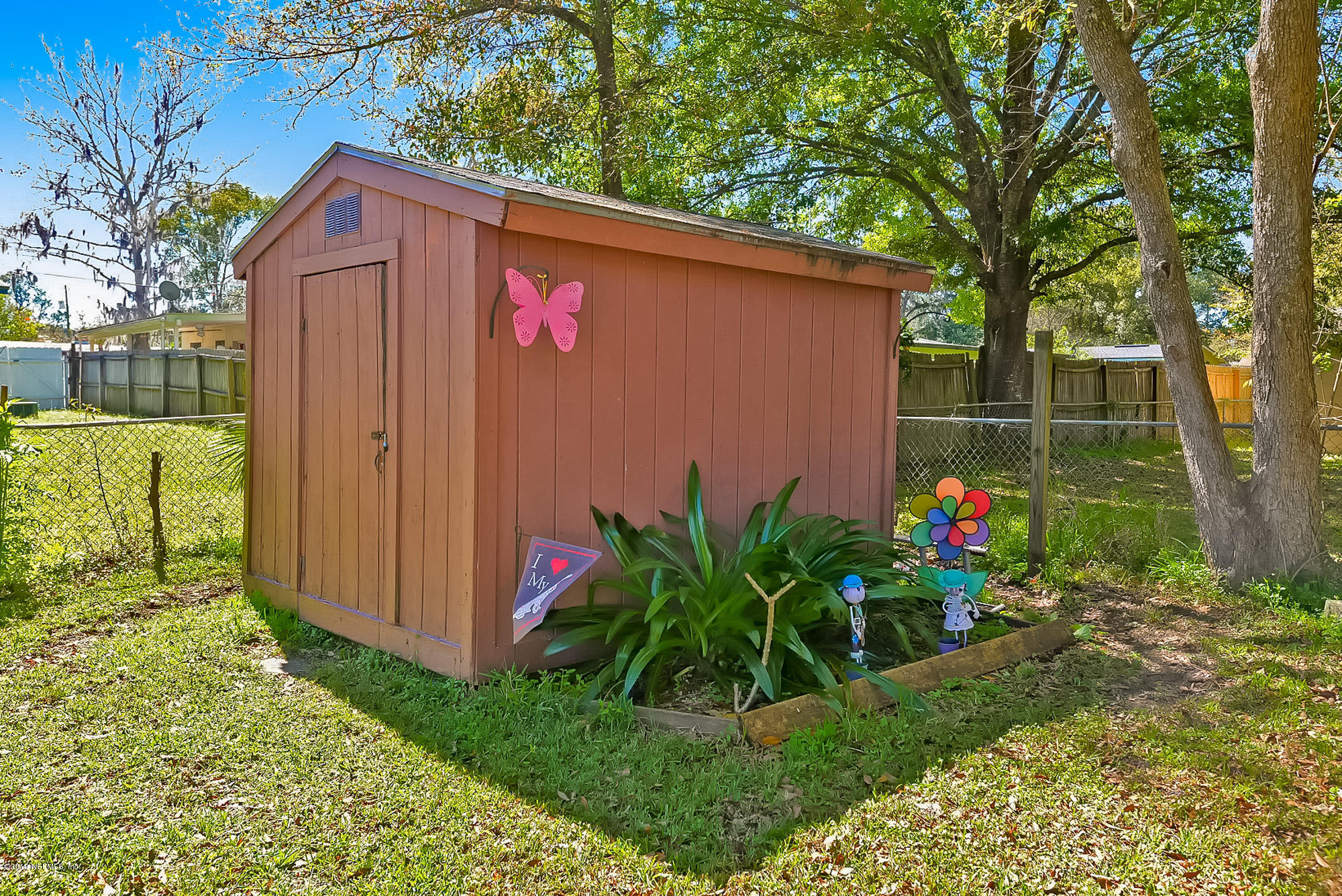 7442 Melvin Road Jacksonville, FL 32210 - Photo 17 of 17 a backyard of a house with lots of green space and fountain