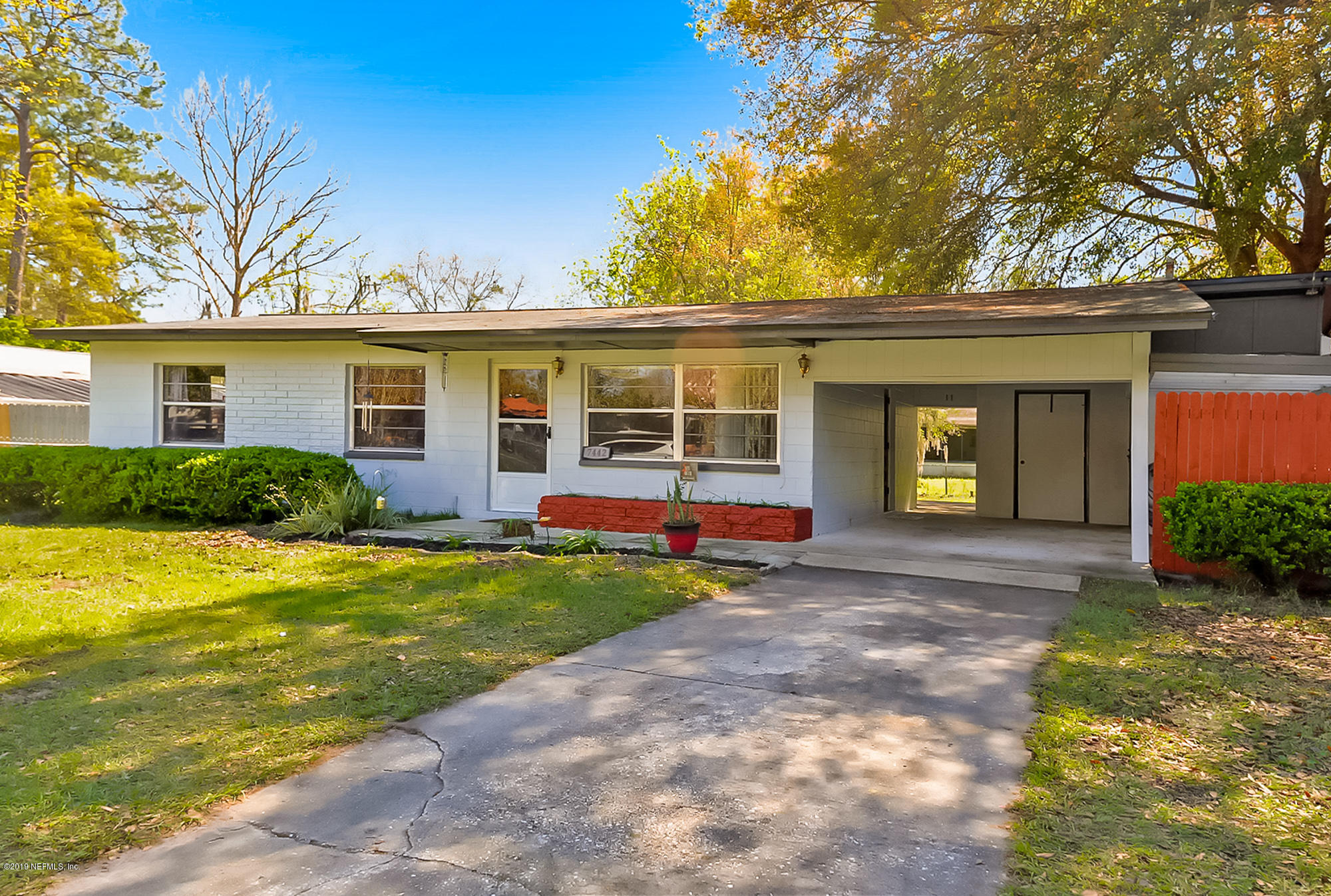 7442 Melvin Road Jacksonville, FL 32210 - Photo 2 of 17 a view of a house with backyard and tree s