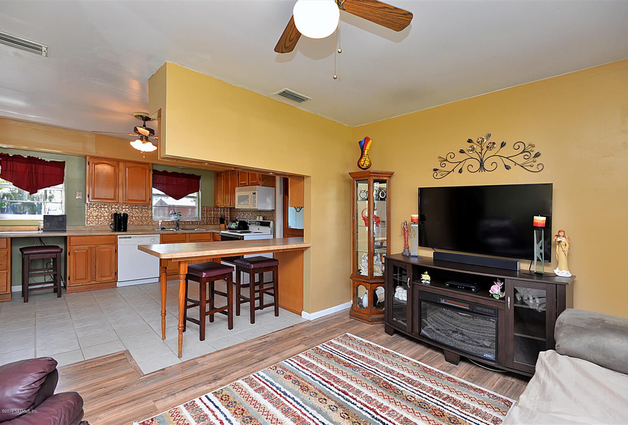 7442 Melvin Road Jacksonville, FL 32210 - Photo 5 of 17 a living room with furniture and a flat screen tv