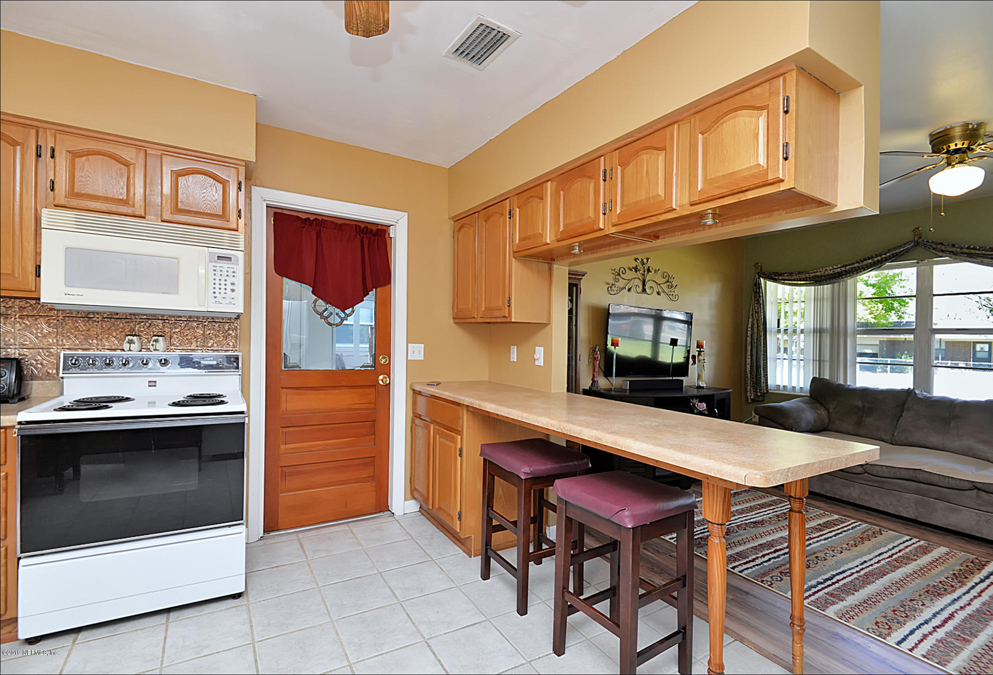 7442 Melvin Road Jacksonville, FL 32210 - Photo 6 of 17 a kitchen with stainless steel appliances granite countertop a stove top oven a sink dishwasher and cabinets with wooden floor