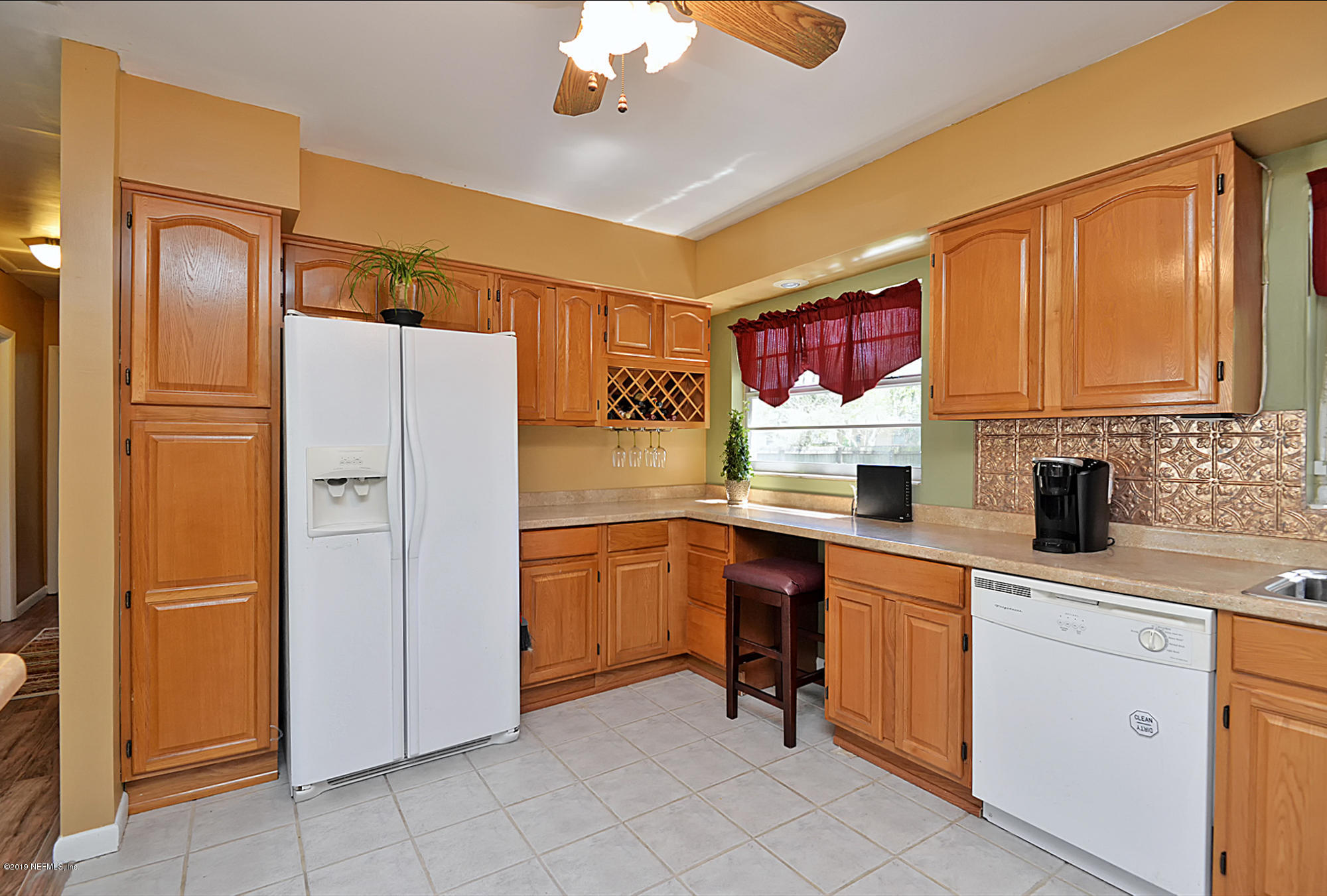 7442 Melvin Road Jacksonville, FL 32210 - Photo 8 of 17 a kitchen with stainless steel appliances granite countertop a refrigerator and a sink