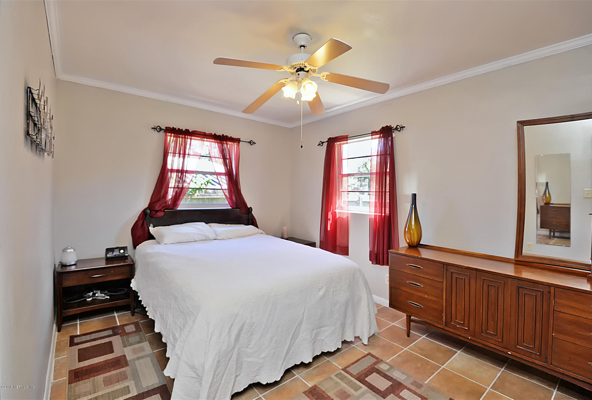 7442 Melvin Road Jacksonville, FL 32210 - Photo 9 of 17 a bedroom with a bed and a window