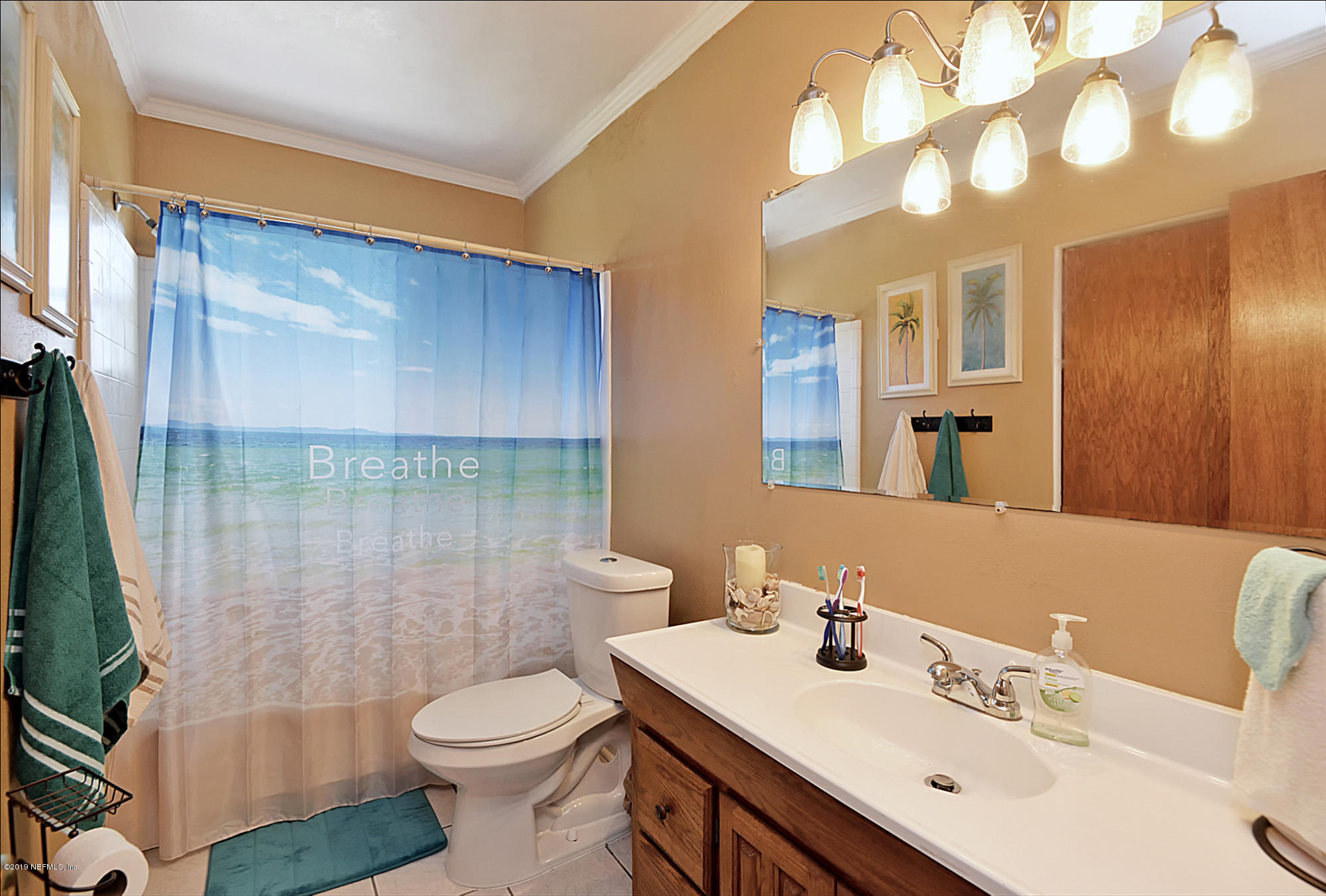 7442 Melvin Road Jacksonville, FL 32210 - Photo 10 of 17 a bathroom with a sink a toilet and shower