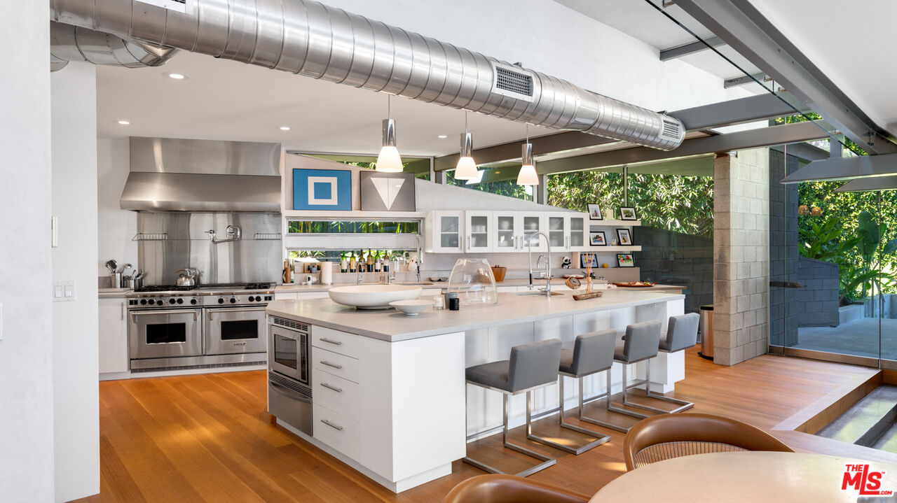 28827 Grayfox Street Malibu, CA 90265 - Photo 19 of 60 a kitchen with stainless steel appliances granite countertop a stove and a refrigerator