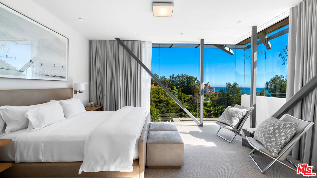 28827 Grayfox Street Malibu, CA 90265 - Photo 27 of 60 a bedroom with a bed a couch and a window