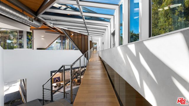 a living room with furniture and large windows