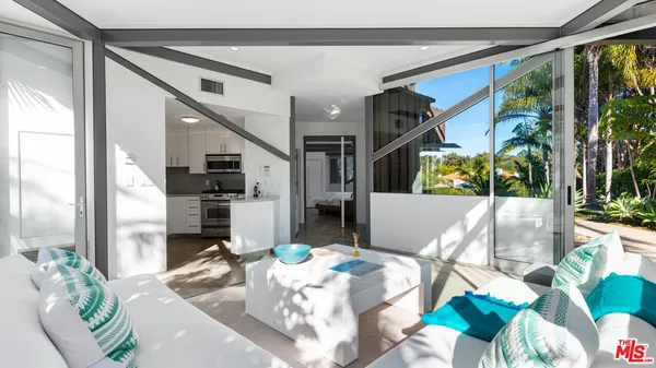 an outdoor space with patio and white umbrellas