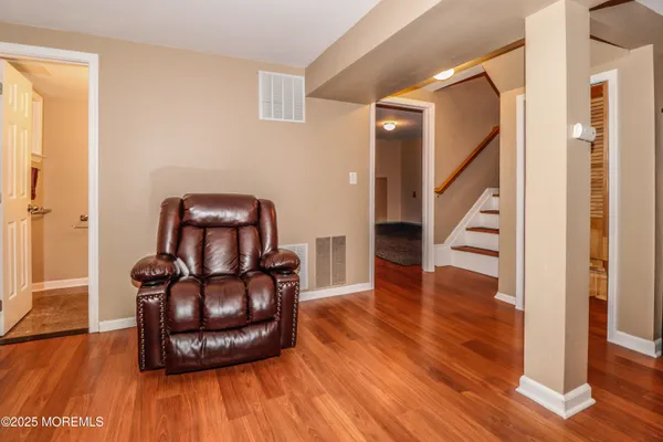 a bedroom with a bed and a mirror on dresser