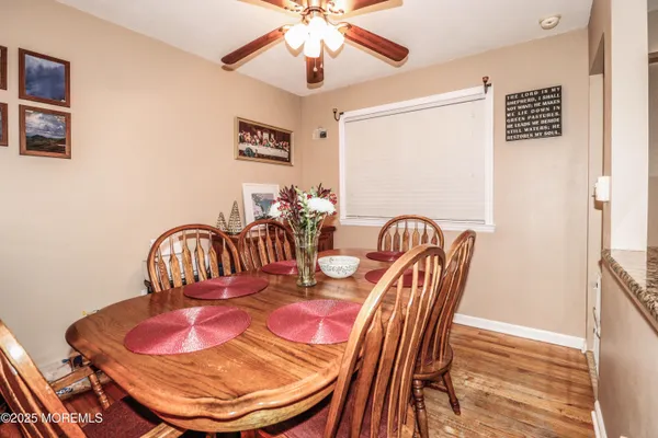 a kitchen with stainless steel appliances granite countertop white cabinets and a stove top oven