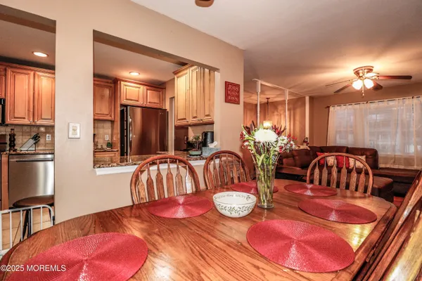 a kitchen with stainless steel appliances granite countertop a refrigerator and a stove top oven