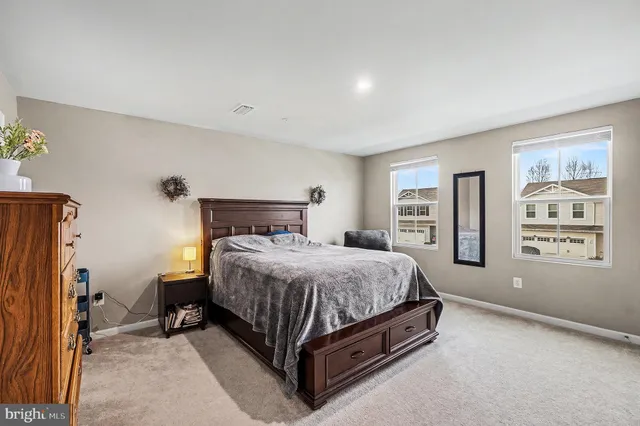 a bedroom with a bed lamp closet and window
