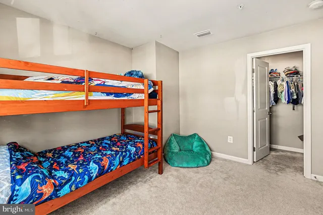 a bedroom with a bed and a baby crib