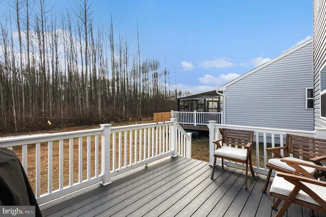 a view of balcony with wooden floor and outdoor seating