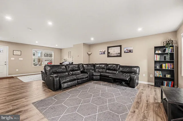 a living room with furniture and a book shelf