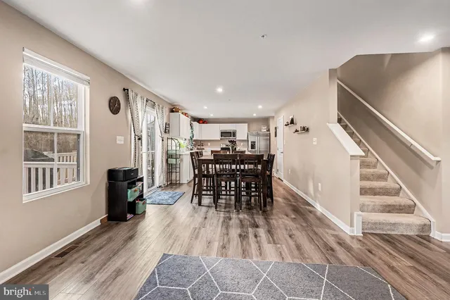 a view of a dining room with furniture and wooden floor