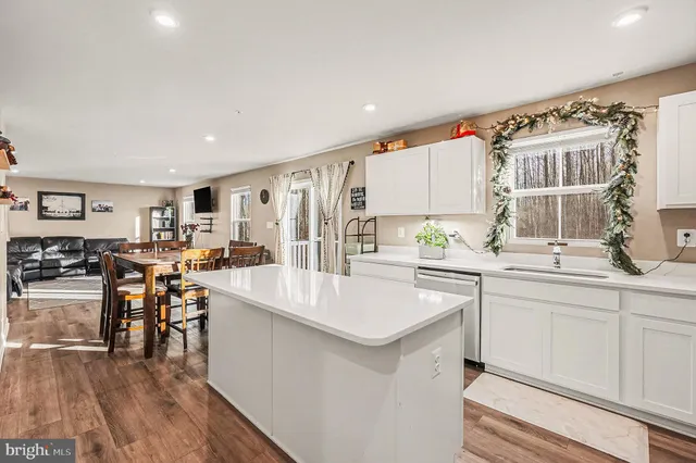 a kitchen with a sink cabinets and wooden floor