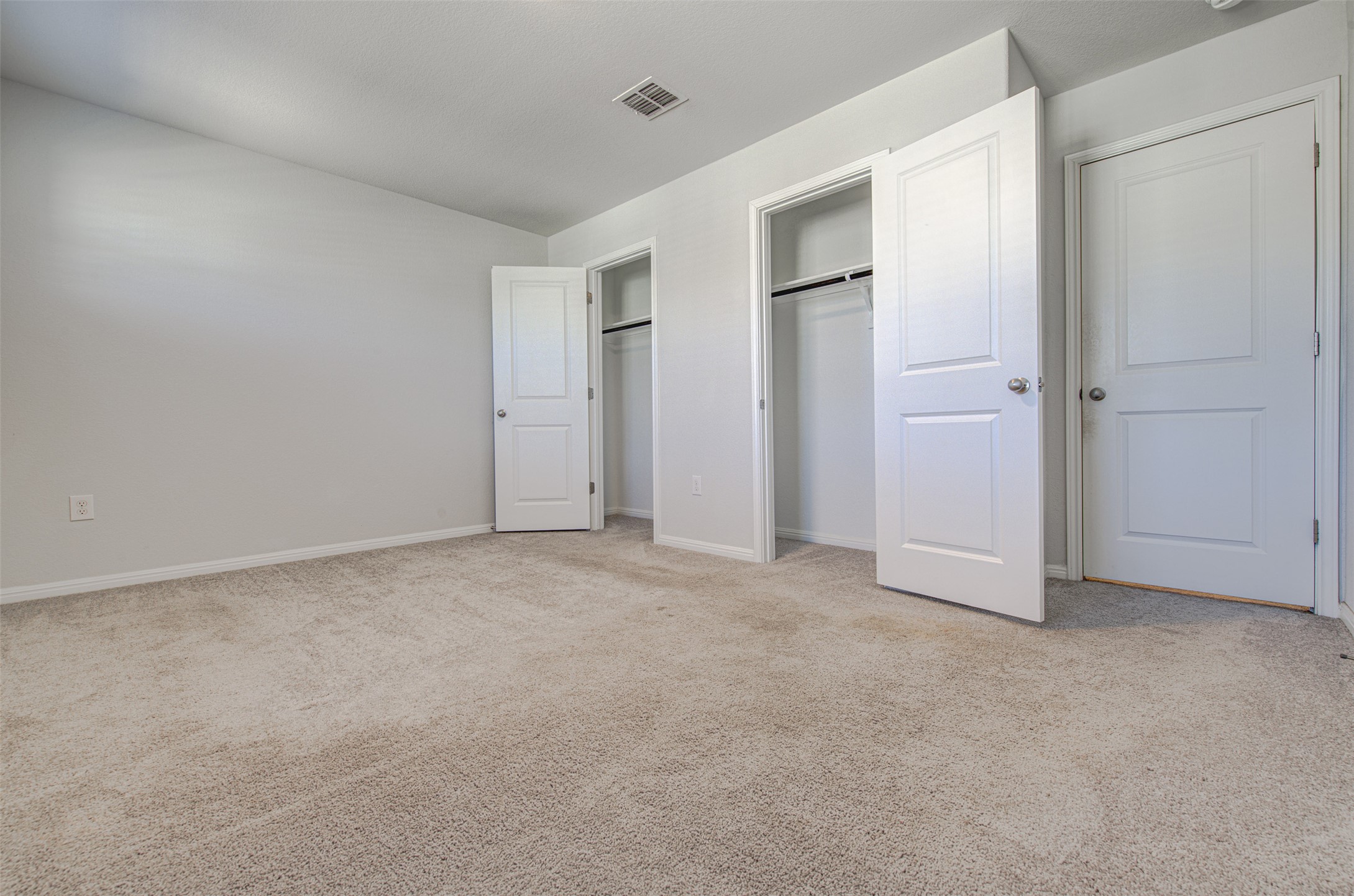 13129 Ditka Drive Manchaca, TX 78652 - Photo 21 of 32 Unfurnished bedroom featuring light carpet and vaulted ceiling