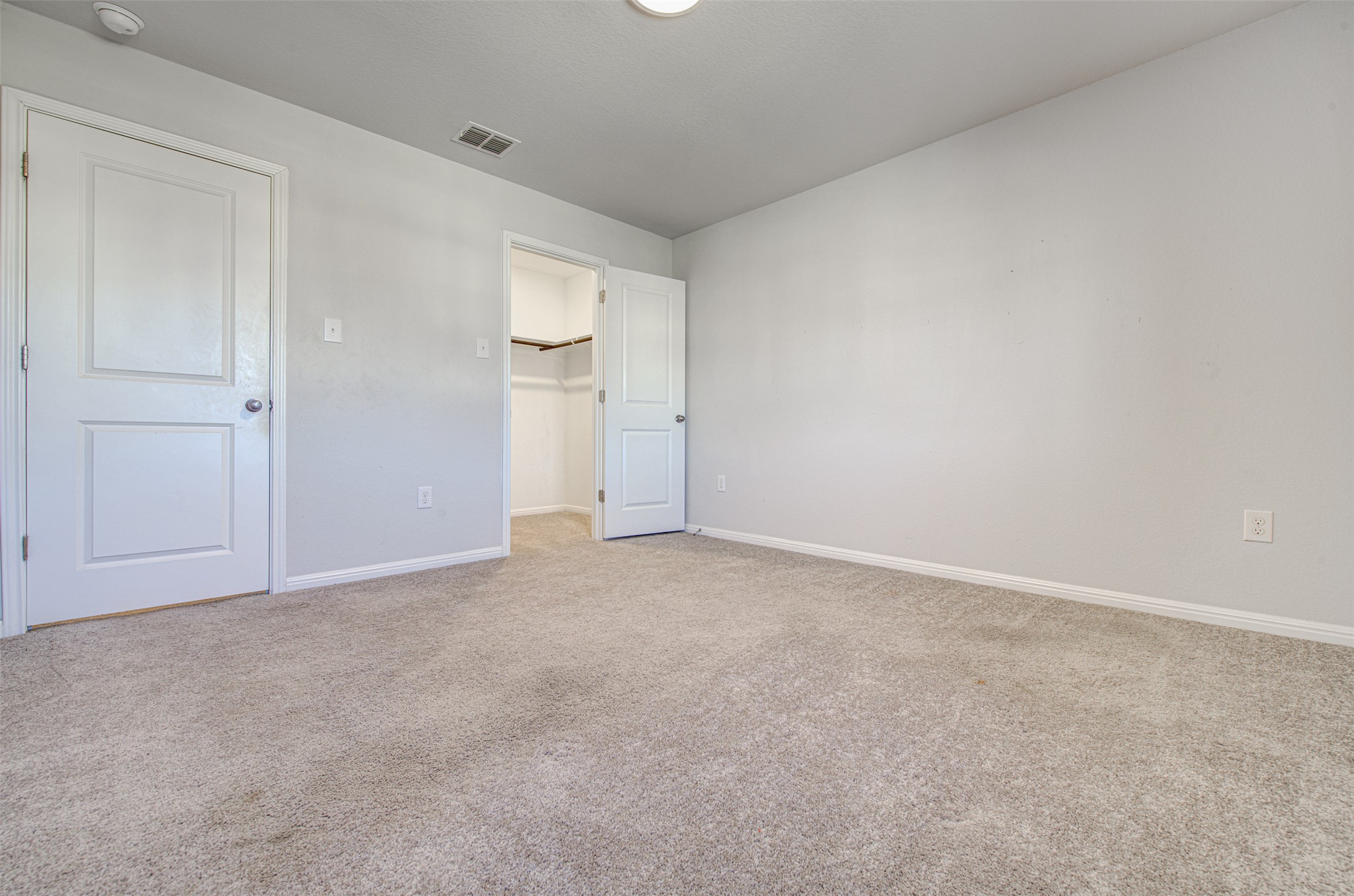 13129 Ditka Drive Manchaca, TX 78652 - Photo 24 of 32 Unfurnished bedroom with a spacious closet and light colored carpet