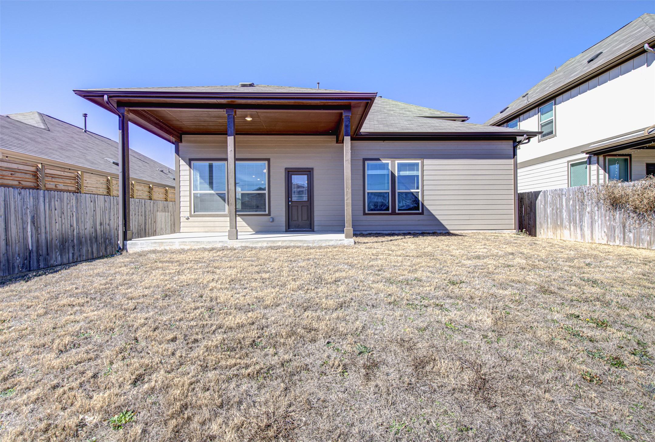 13129 Ditka Drive Manchaca, TX 78652 - Photo 29 of 32 Back of property with a patio and a fenced backyard