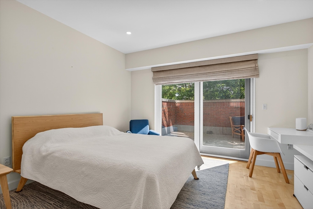 10 Bowdoin Street, Unit 202 Boston, MA 02114 - Photo 11 of 16 a bedroom with a bed and a large window