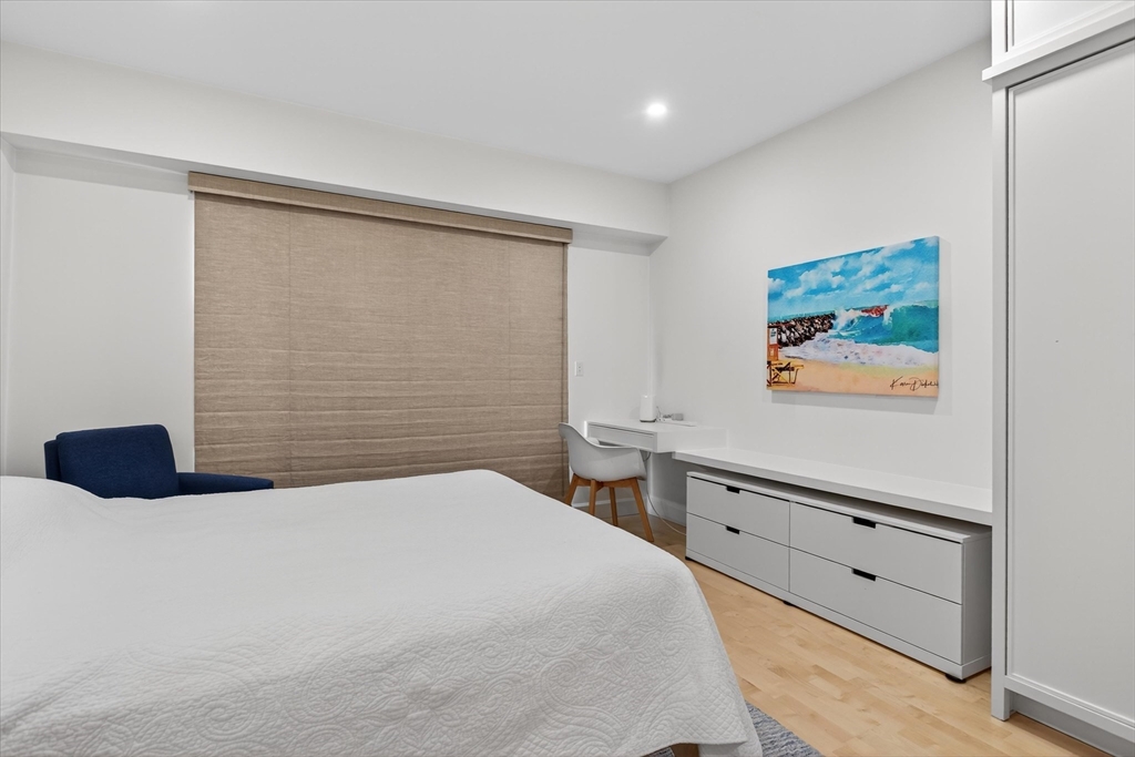 10 Bowdoin Street, Unit 202 Boston, MA 02114 - Photo 12 of 16 a bedroom with a bed and a painting on the wall