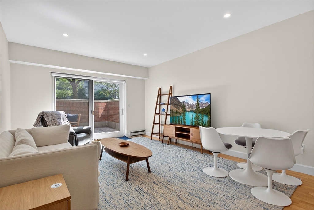 10 Bowdoin Street, Unit 202 Boston, MA 02114 - Photo 4 of 16 a living room with furniture and a window