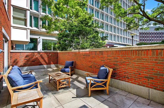 a backyard of a house with outdoor seating