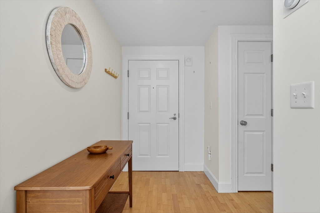 10 Bowdoin Street, Unit 202 Boston, MA 02114 - Photo 8 of 16 a room with a door and a mirror