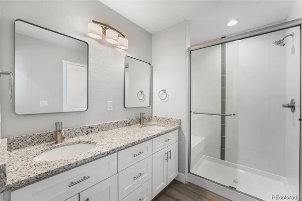a bathroom with a granite countertop sink mirror and double