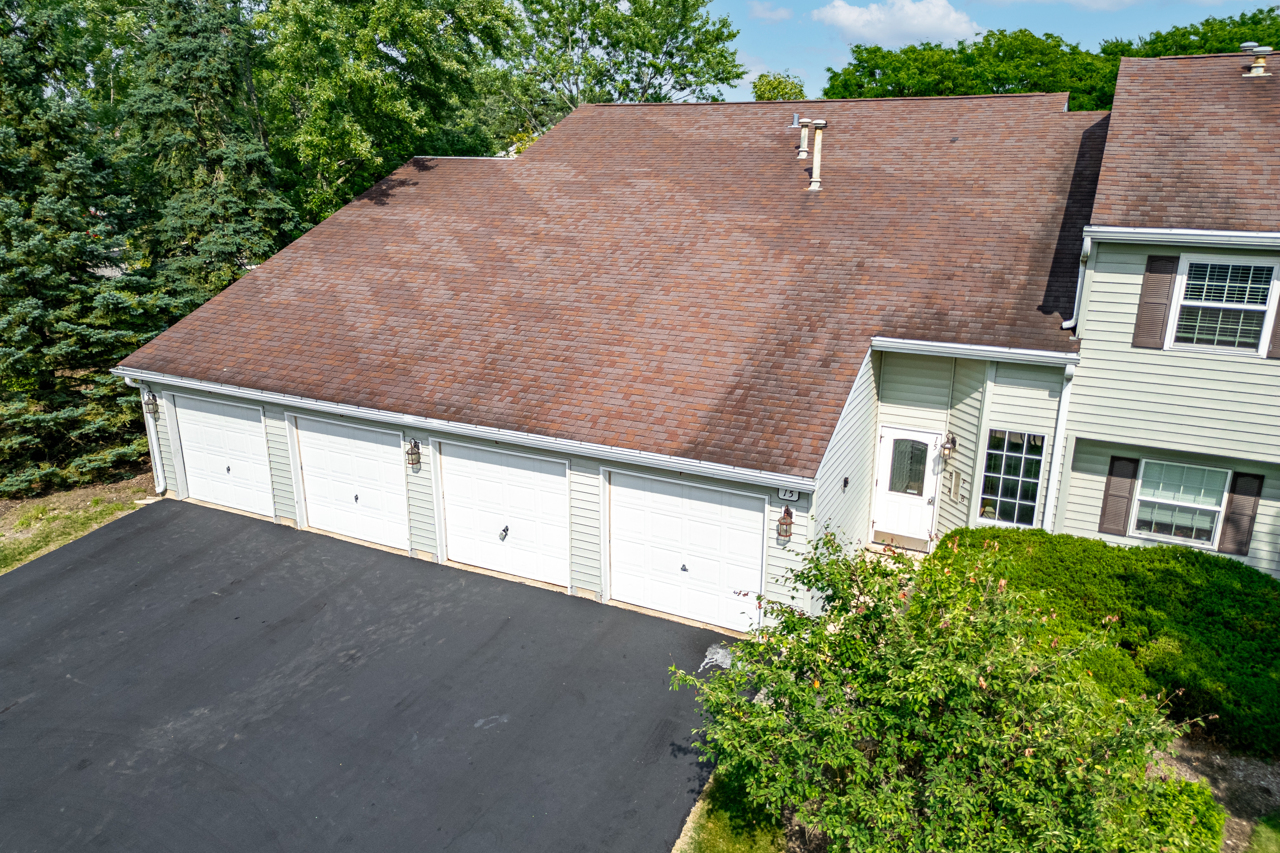 15 Gant Circle, Unit E Streamwood, IL 60107 - Photo 2 of 21 a aerial view of a house with a yard and garage