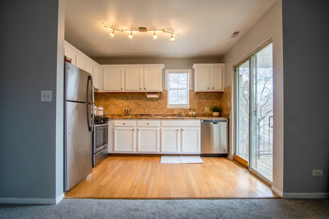 a kitchen with a refrigerator and cabinets